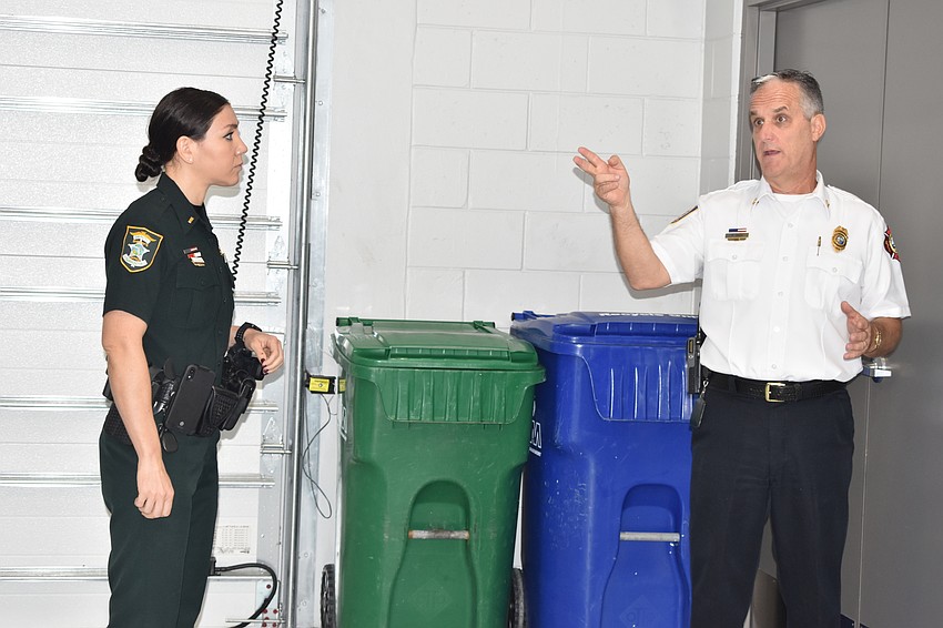 Sarasota County Lt. Michelle DiCapua watches as Longboat Key Fire Chief Paul Dezzi provides a tour of Fire Station 92.