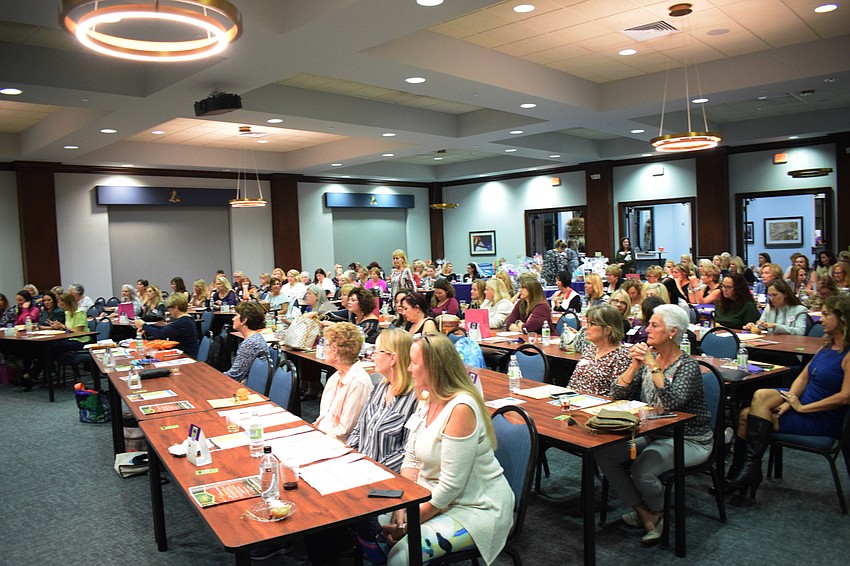 The room is filled with women ready to win designer bags.