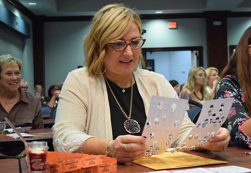 Allison Imre Perkowski checks her Bingo cards to see if she has the numbers being called.