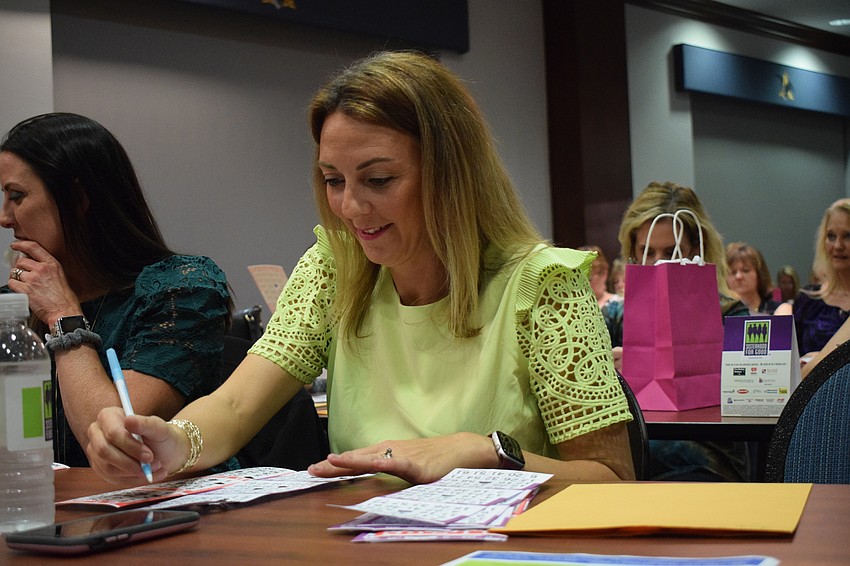 Sarasota's Sumer Creasy crosses off the numbers she has that are being called.