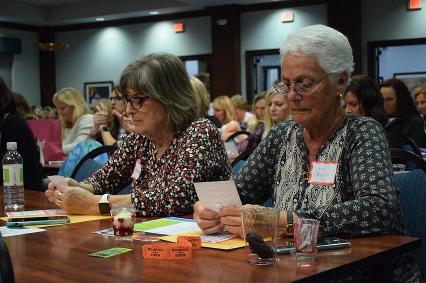 Sarasota's Carol Masio and Janet Masio watch their cards to see if any of their numbers are called. 