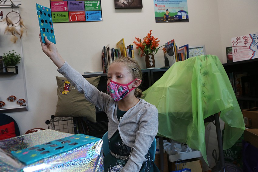 Caedance Day waves customers over.