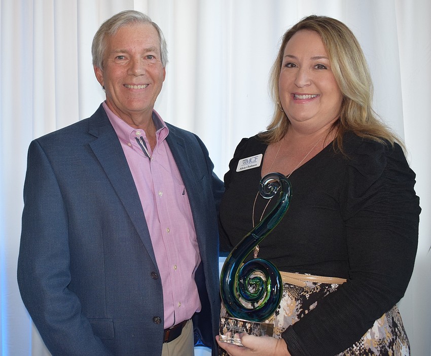 David Sessions of Willis Smith presents Alicia Chalmers of the Manatee Community Foundation the Ray of Sunshine award.
