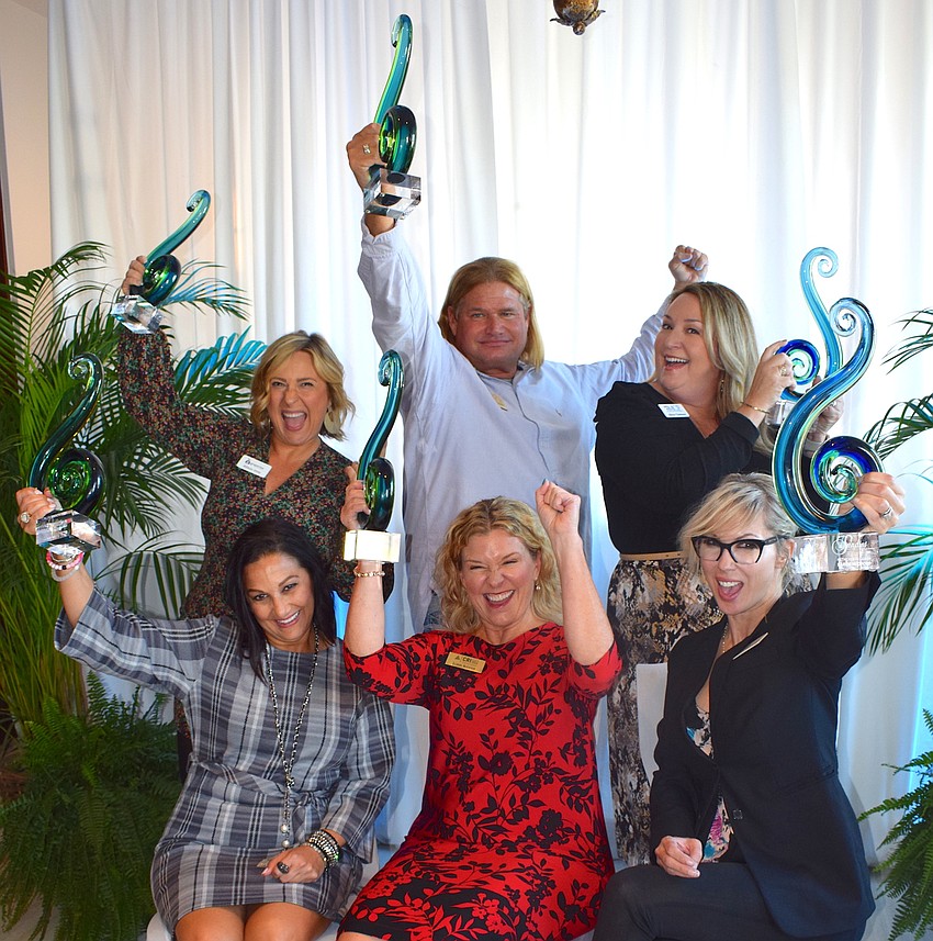 Allison Imre Perkowski, Ron Trytek, and Alicia Chalmers (in back) and Michelle Olivo, Lorri Kidder and Karen Medford (front) have plenty to celebrate after winning Sandies awards.