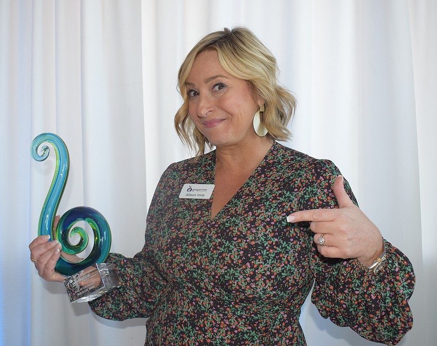 Allison Imre Perkowski has some fun with her Bull by the Horns Sandies award.
