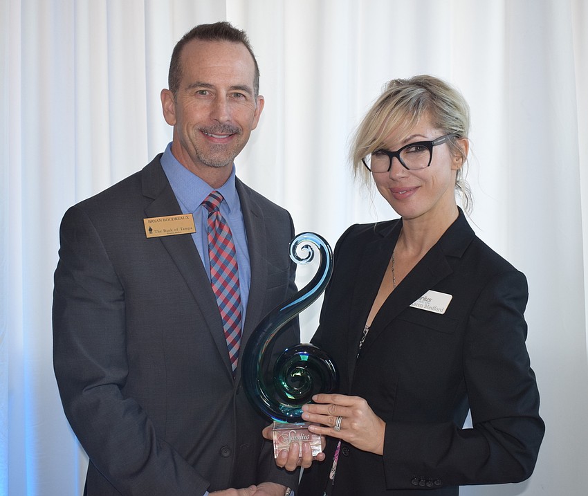 Bryan Boudreaux of The Bank of Tampa, presents the Networking Queen award to Karen Medford of Sirius Day Spa.