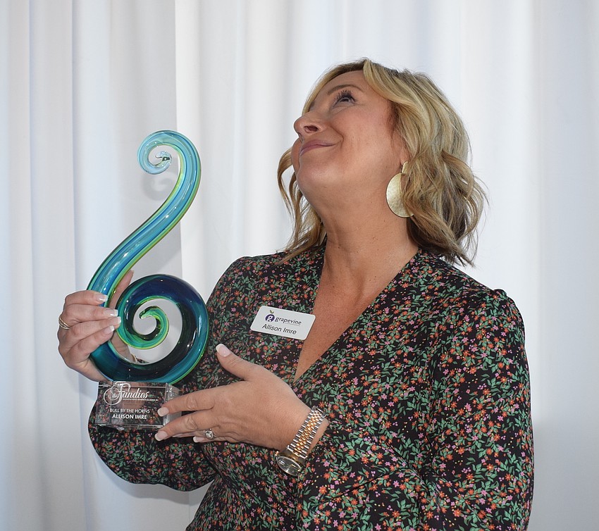 Allison Imre Perkowski has a little fun with her Bull by the Horns award.