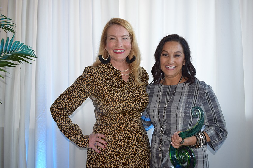 Observer Media Group's Emily Walsh presents the Networking Queen award to Michelle Olivo of Current Technologies.