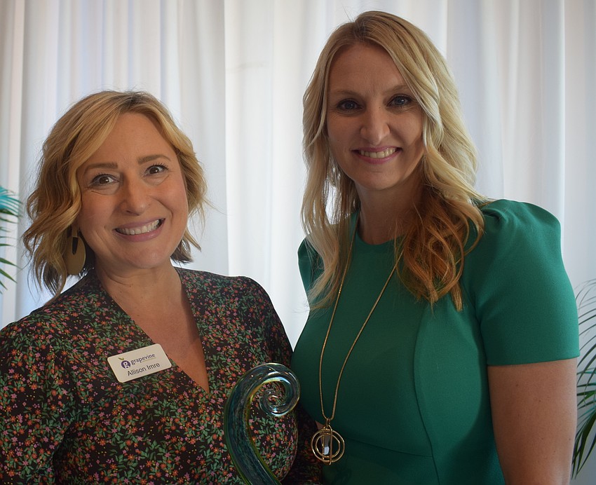 Allison Imre Perkowski received her Bull by the Horns award from past LWRBA chair Heather Williams.