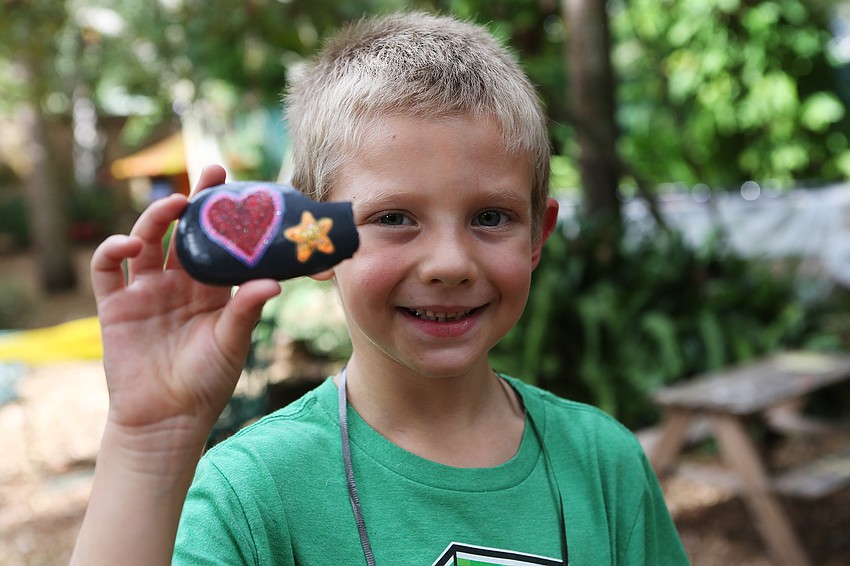 Royal Chaffee proudly displays the rock he found.