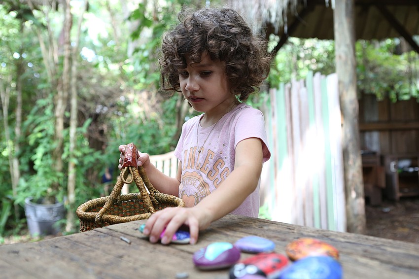 Violet Viola puts her rocks back in her basket.