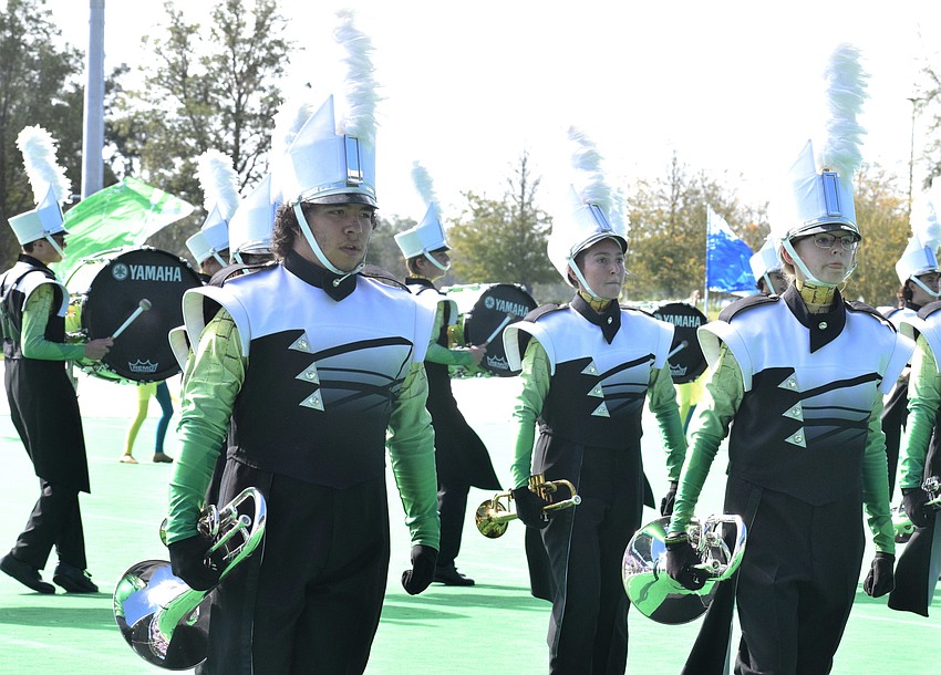 Lakewood Ranch High School's Dakota Lowell, Abigail Newton and Katie Powers march on.