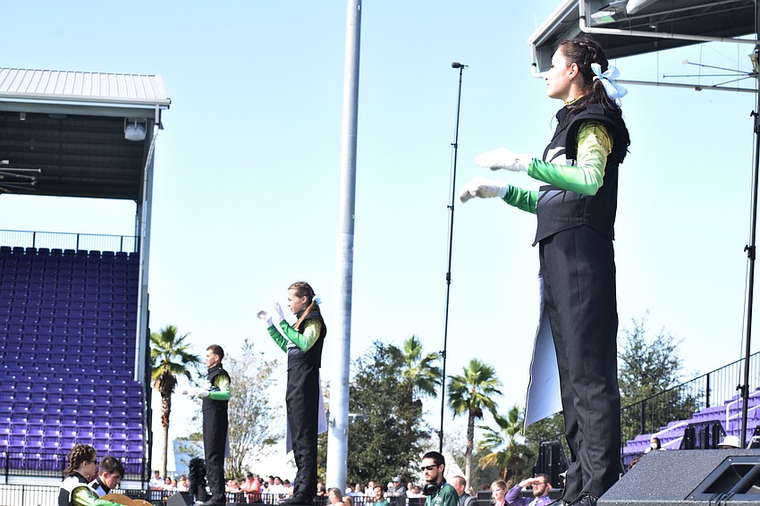 Lakewood Ranch High drum majors Ben Rosasco, Maya Lander and Lana DiBiase lead the band during its semifinals performance.