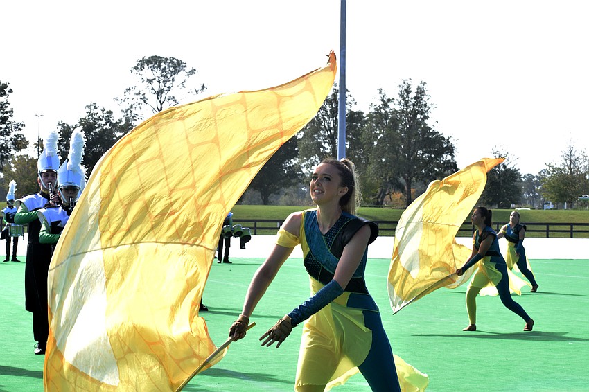 Paige Thompson, a Lakewood Ranch High color guard member, twirls her flag.