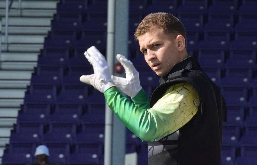 Ben Rosasco, a senior in the Marching Mustangs, conducts.