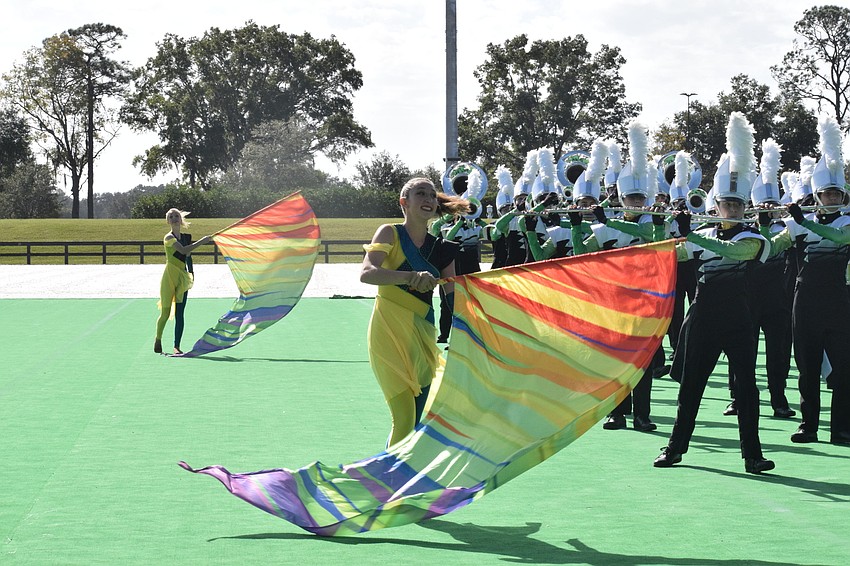 Lakewood Ranch High's Jasmine Burden twirls her flag in unison with the rest of the color guard.