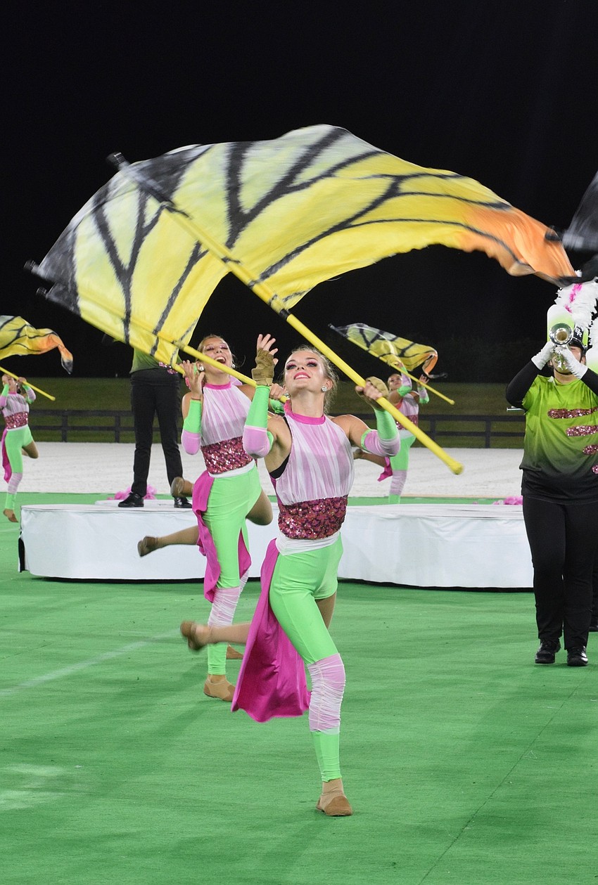 Braden River High's Lily Vasquez and Krysten Collins twirl their flags in unison.