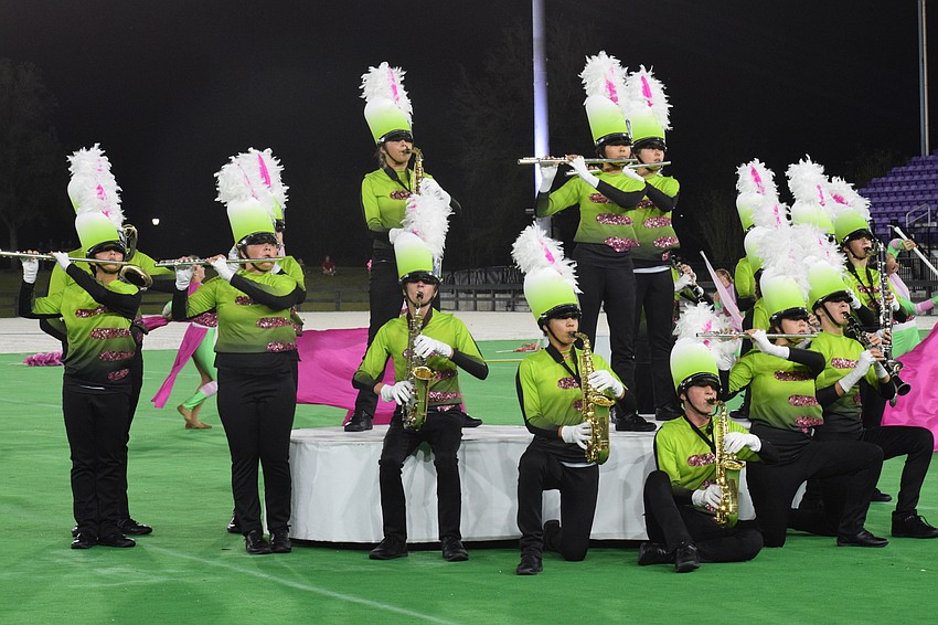 Members of the Marching Band of Pirates are pleased with their final performance of the season.
