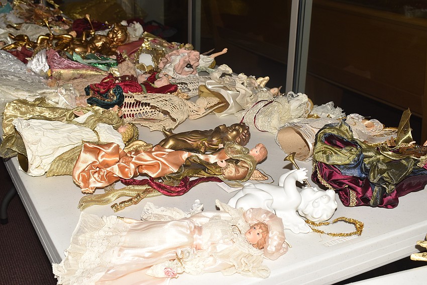 Dozens of angel figurines and ornaments awaited their place on the tree.