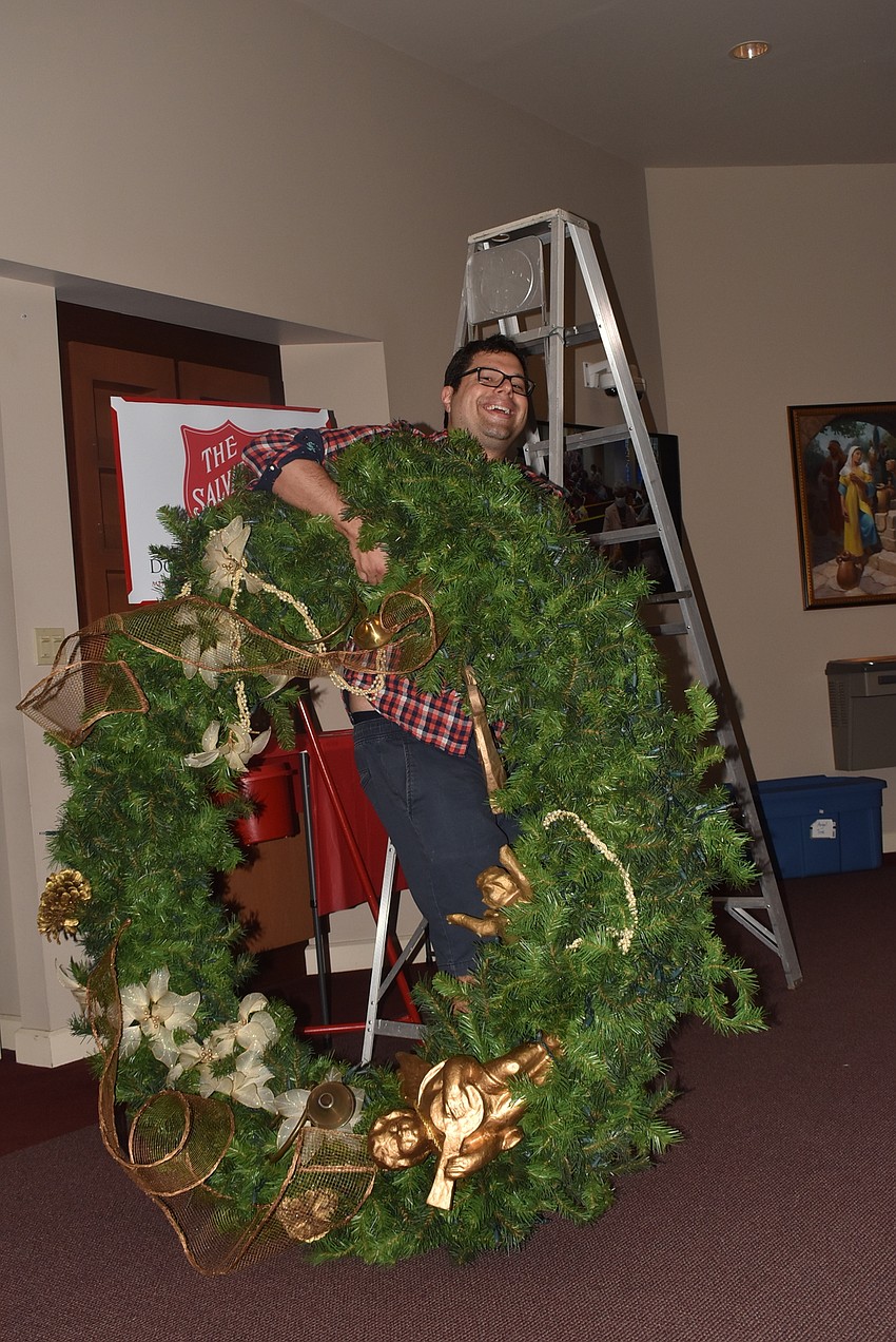 Michael Bodnyk carries a wreath to be hung.