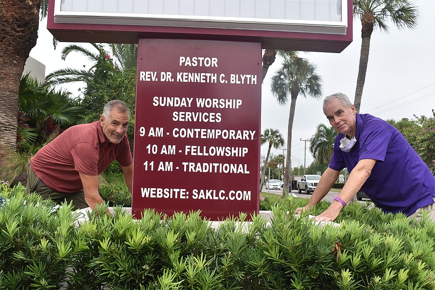Maintenance technician Larry Romer and Paul Thurner plug in extension cords outside.