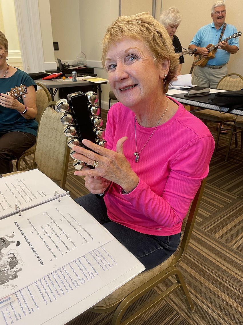 Clare Baron gets into the spirit by playing the bells during Rudoph the Red Nosed Reindeer.