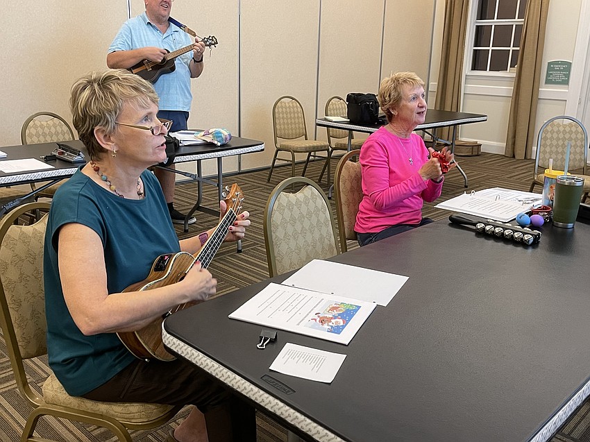 Penny Robinson and Clare Barone study musical notes between songs during a Nov. 22 jam session at Lakewood Ranch Town Hall.
