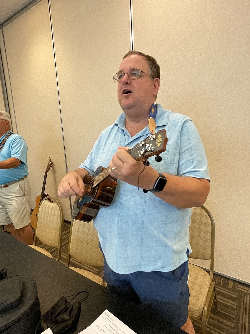 Carl Backman strums his ukulele and sings Mele Kalikimaka.