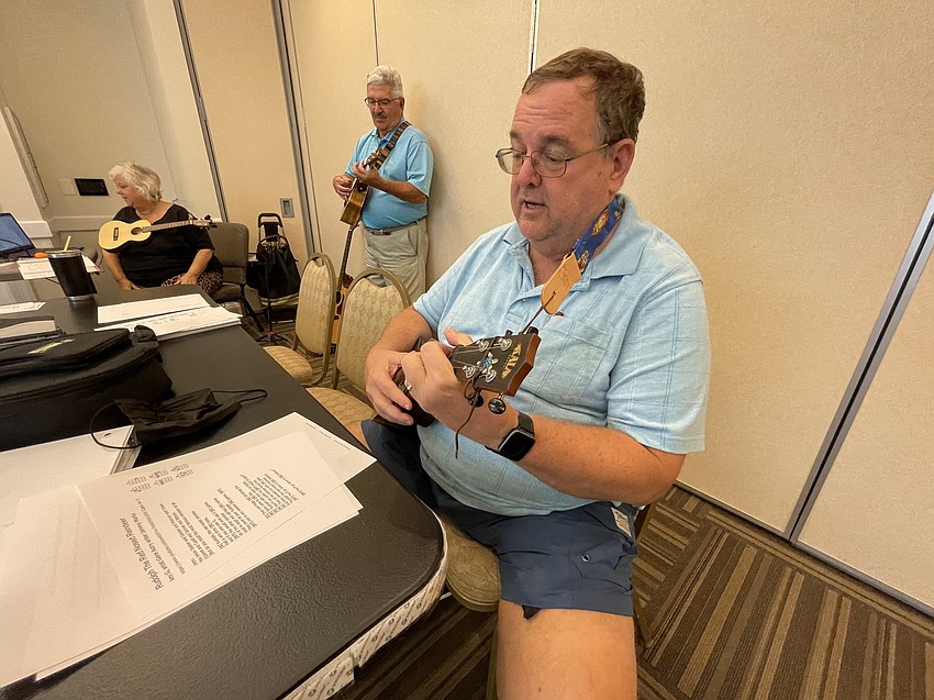 Alice Baumann, Dave Barone and Carl Backman get musical notes ready to play Rudolph the Red Nosed Reindeer.