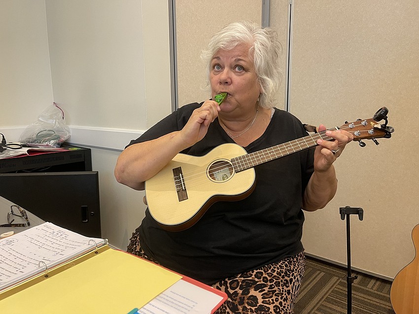 Alice Baumann plays both the ukulele and a kazoo to Rudolph the Red Nosed Reindeer.