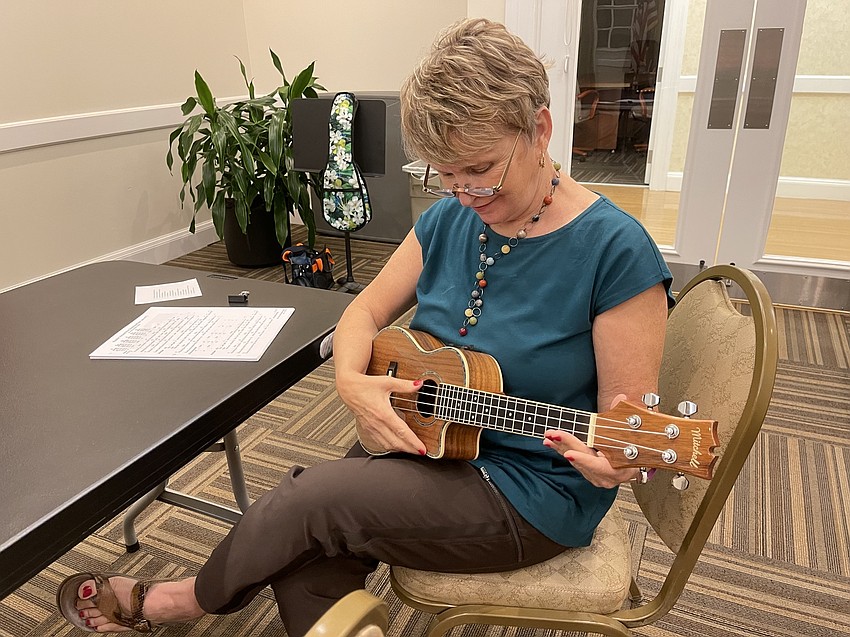 Penny Gibson plays a few notes on her ukulele.