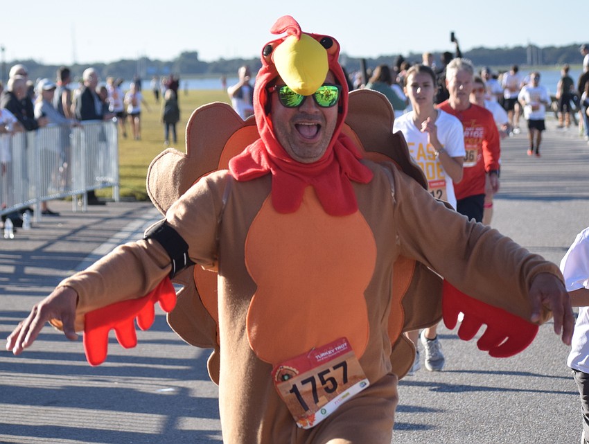 Philadelphia's Alex Rendon flaps his wings to finish the Florida Turkey Trot 5K at Nathan Benderson Park in Sarasota on Thanksgiving morning. 