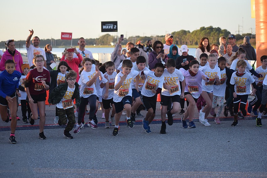 Runners take off at the start of a Kids Turkey Dash.