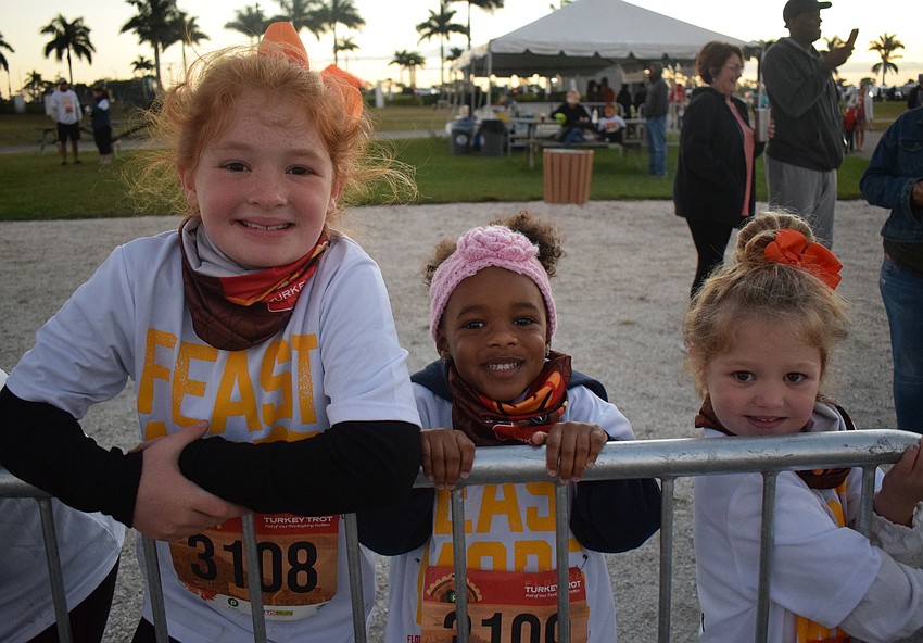 Sarasota's Rivyr Goins, 7, Eden Williams, 3, and Jane Goins, 4, have a little fun before the Florida Turkey Trot at Nathan Benderson Park.