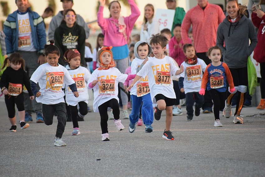 Runners speed away from the start of the Kids Turkey Dash.