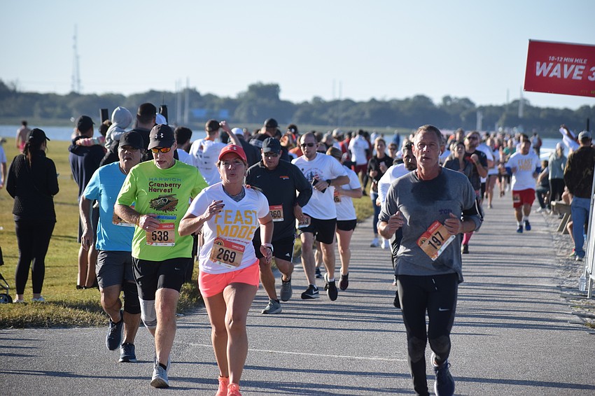 Runners stream to the finish line of the Florida Turkey Trot at Nathan Benderson Park.