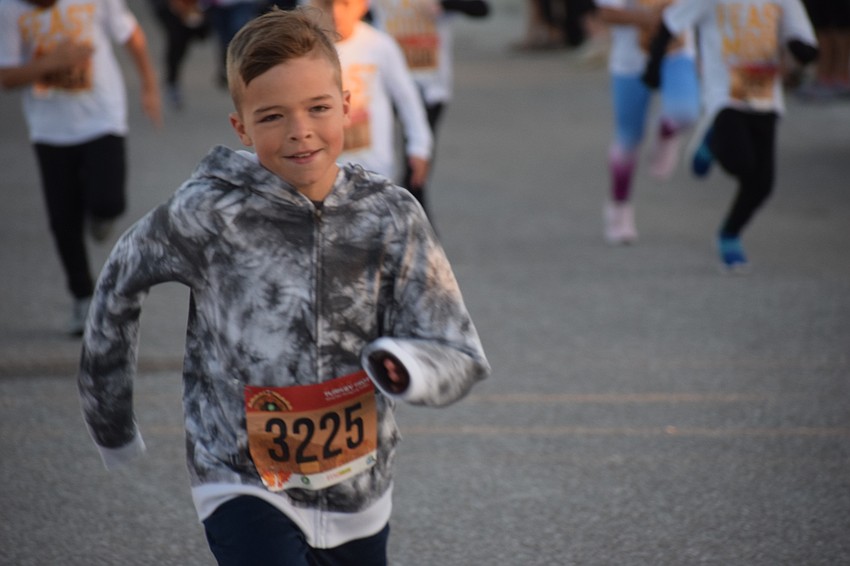 Parrish 9-year-old Kade Backman speeds to the front of the Kids Turkey Dash.