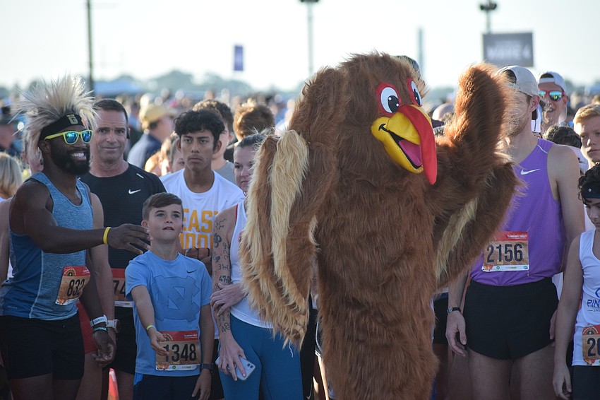 Troy the Turkey fires up runners before the start of the 5K.
