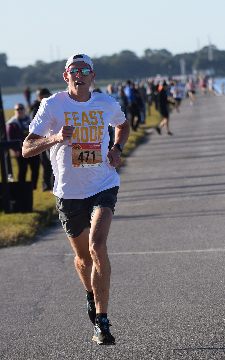 Race winner Jordan Tropf of Washington, D.C., took time out of a family visit to win the Florida Turkey Trot in 16:14.