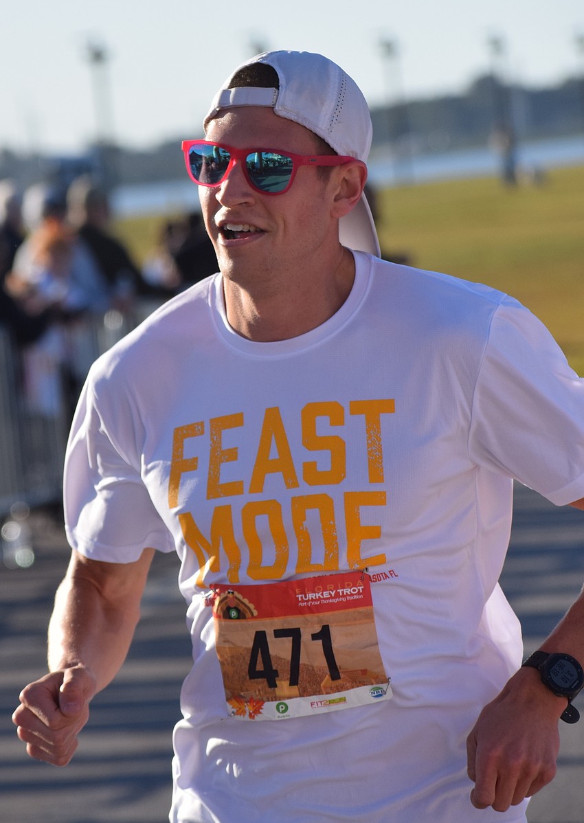 Jordan Tropf of Washington D.C. crosses the finish line to win the Florida Turkey Trot at Nathan Benderson Park on Thanksgiving morning.