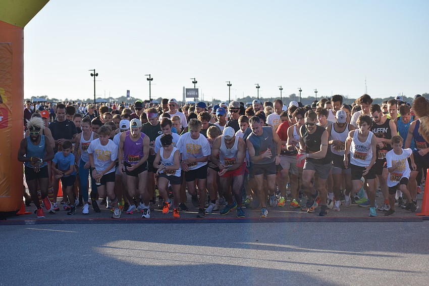 Runners take off at the start of the Florida Turkey Trot on Thanksgiving morning at Nathan Benderson Park.