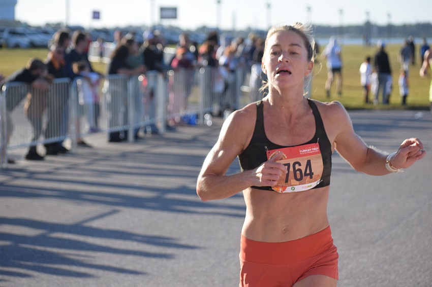 Sarasota's Katie Reynolds is the first woman to finish the Florida Turkey Trot. She also won the 40-44 age division. Reynolds finished in 18:30 and was the 13th overall finisher.
