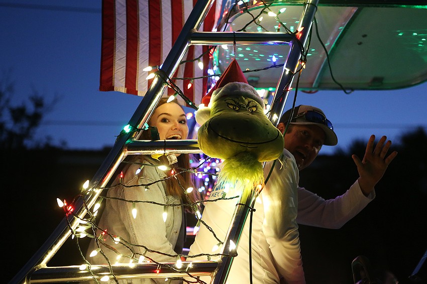 Groups decorate boats in cheery Christmas stylings.