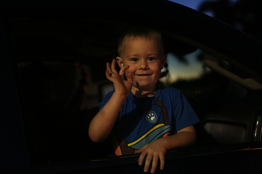 Reed Longenbach waves from a car.