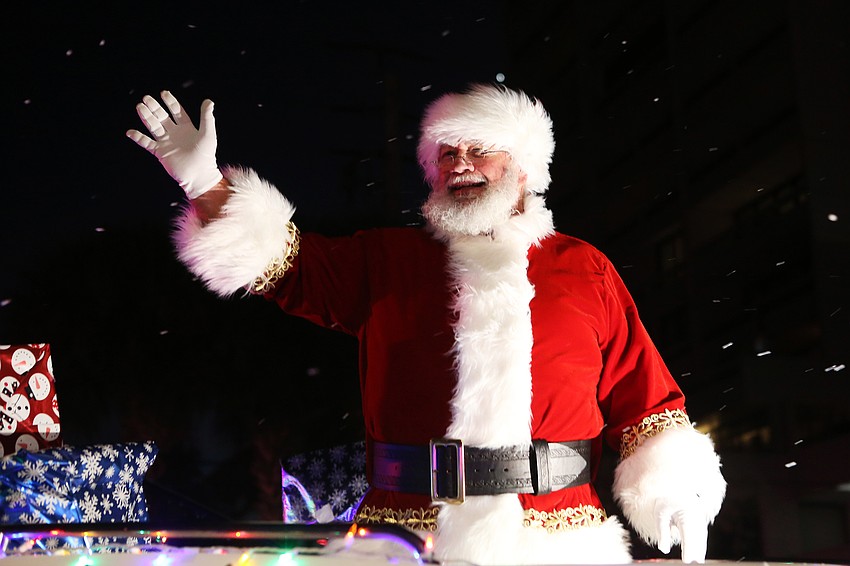 Santa Claus waves to enormous cheers and applause.