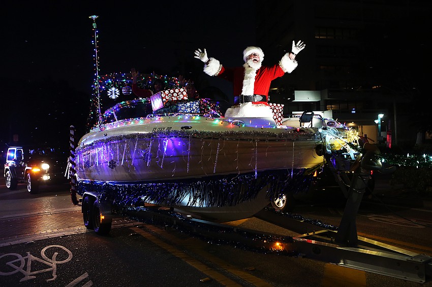 Santa Claus waves to enormous cheers and applause.