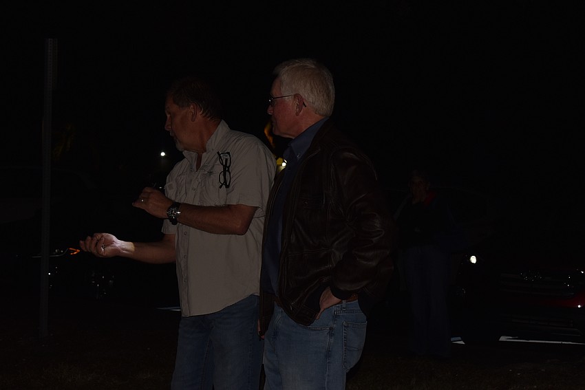 Mark Meador and Ken Schneier fiddle with the light switch.