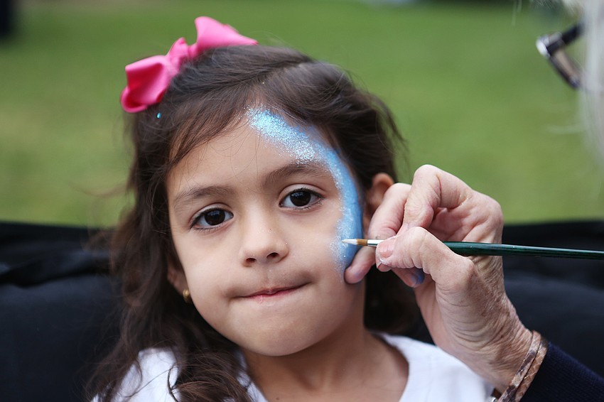 Antonella Sifuentes has her face painted.