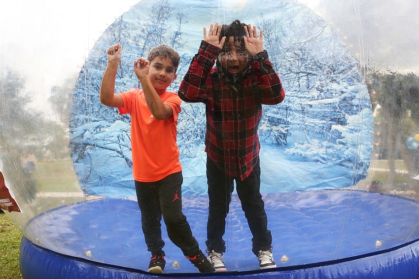 Ethan Colgrove and Blake Brown go into a giant snow globe.