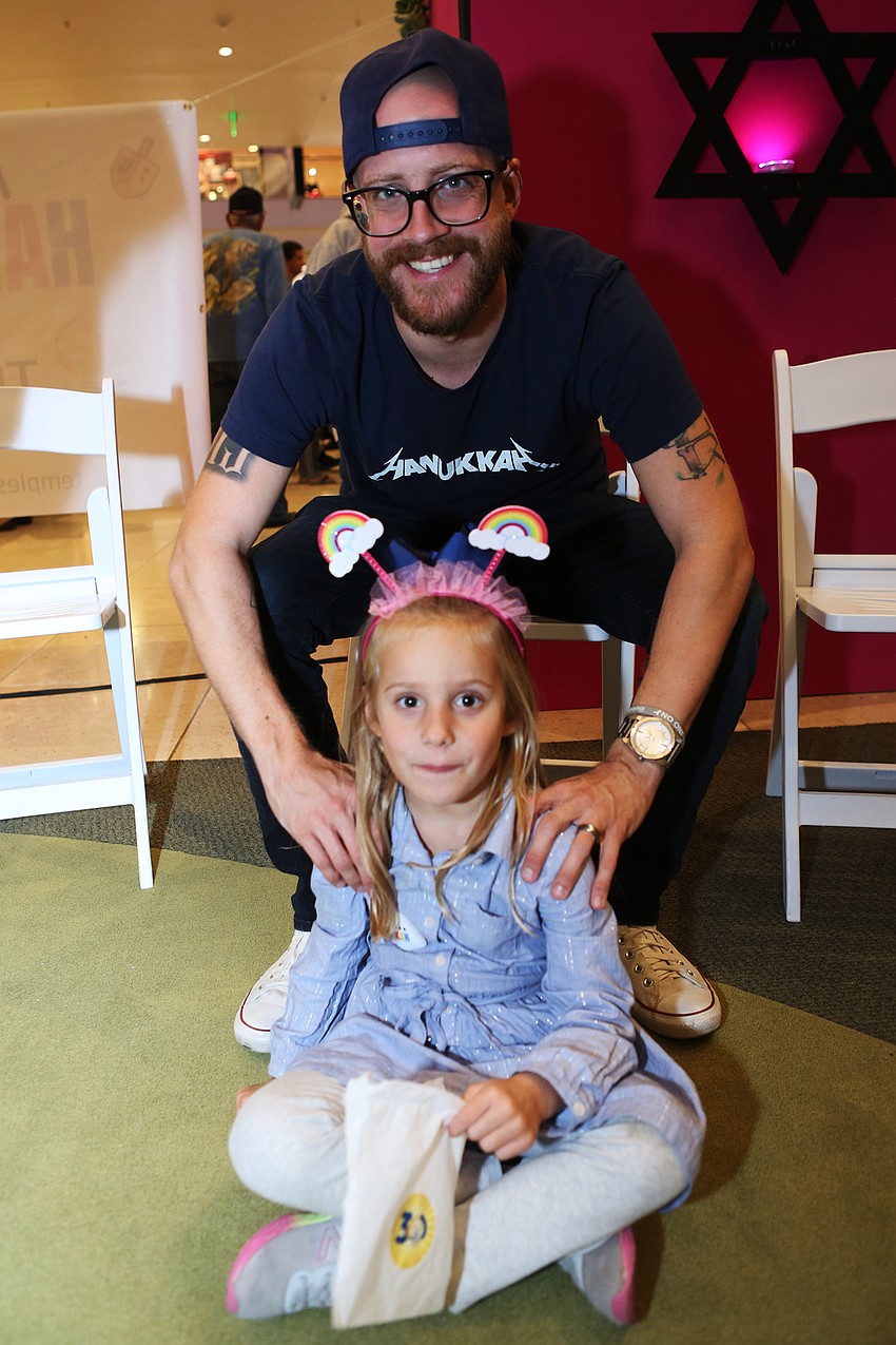 Luke and Rene Harper sit and listen to the story.